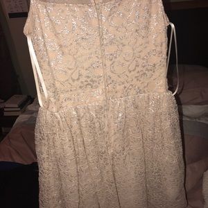 A cream dress with sequence around the waist.